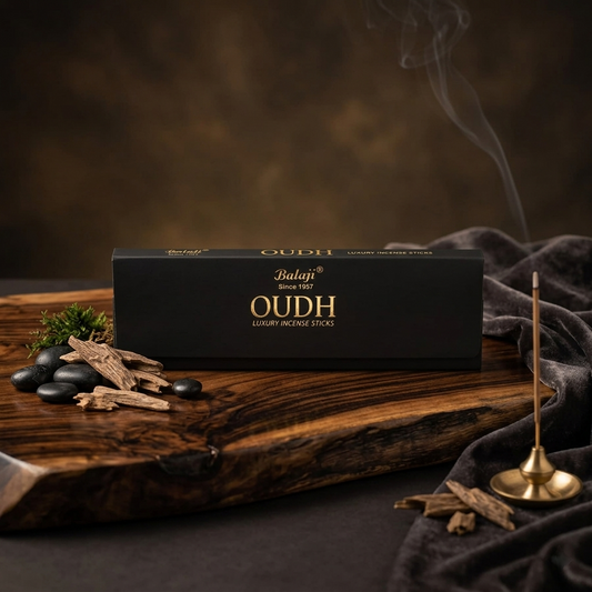 Balaji Oudh incense sticks packaging on a wooden surface with incense sticks and smoke.
